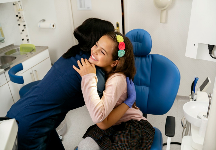 orthodontist giving a hug to smiling patient