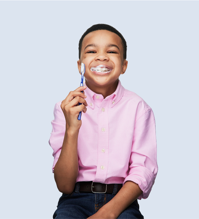 smiling child brushing teeth