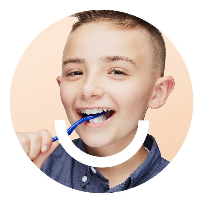 smiling boy brushing teeth