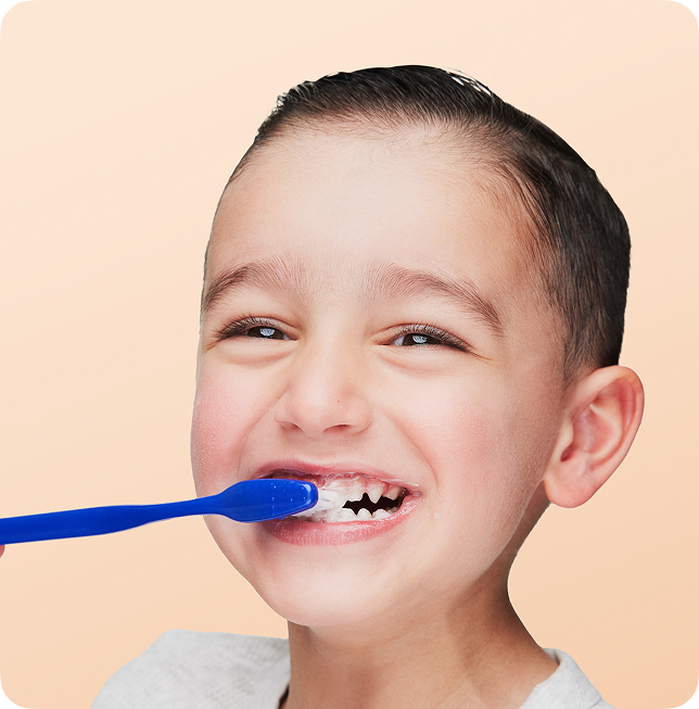 young boy brushing teeth