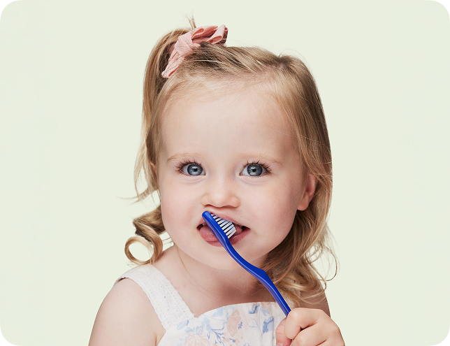 young girl brushing teeth