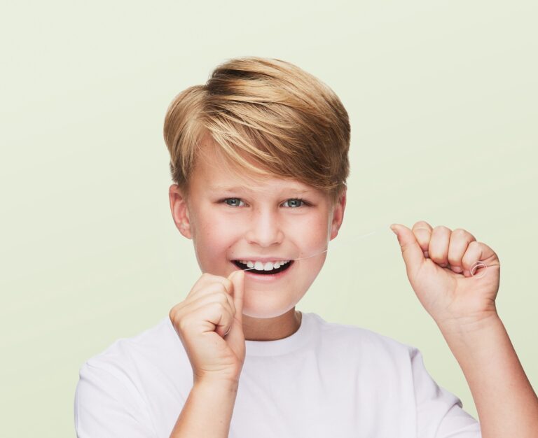 A Young Boy Flossing