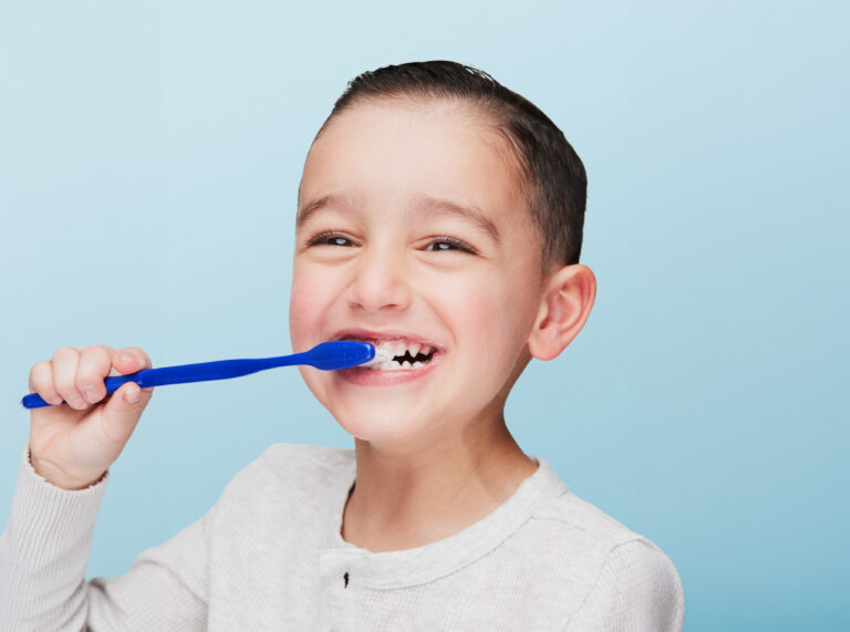 Portrait Of A Young Boy With A Toothbrush